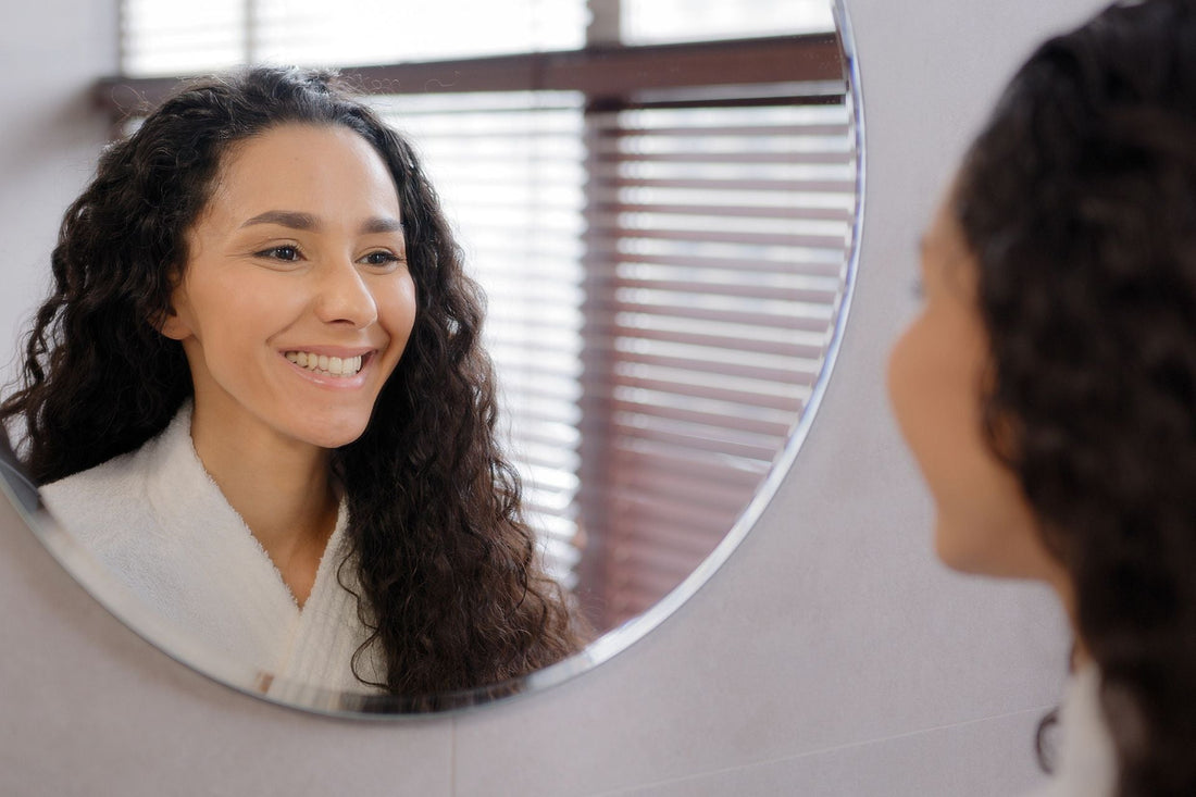 Woman looking in the mirror. 